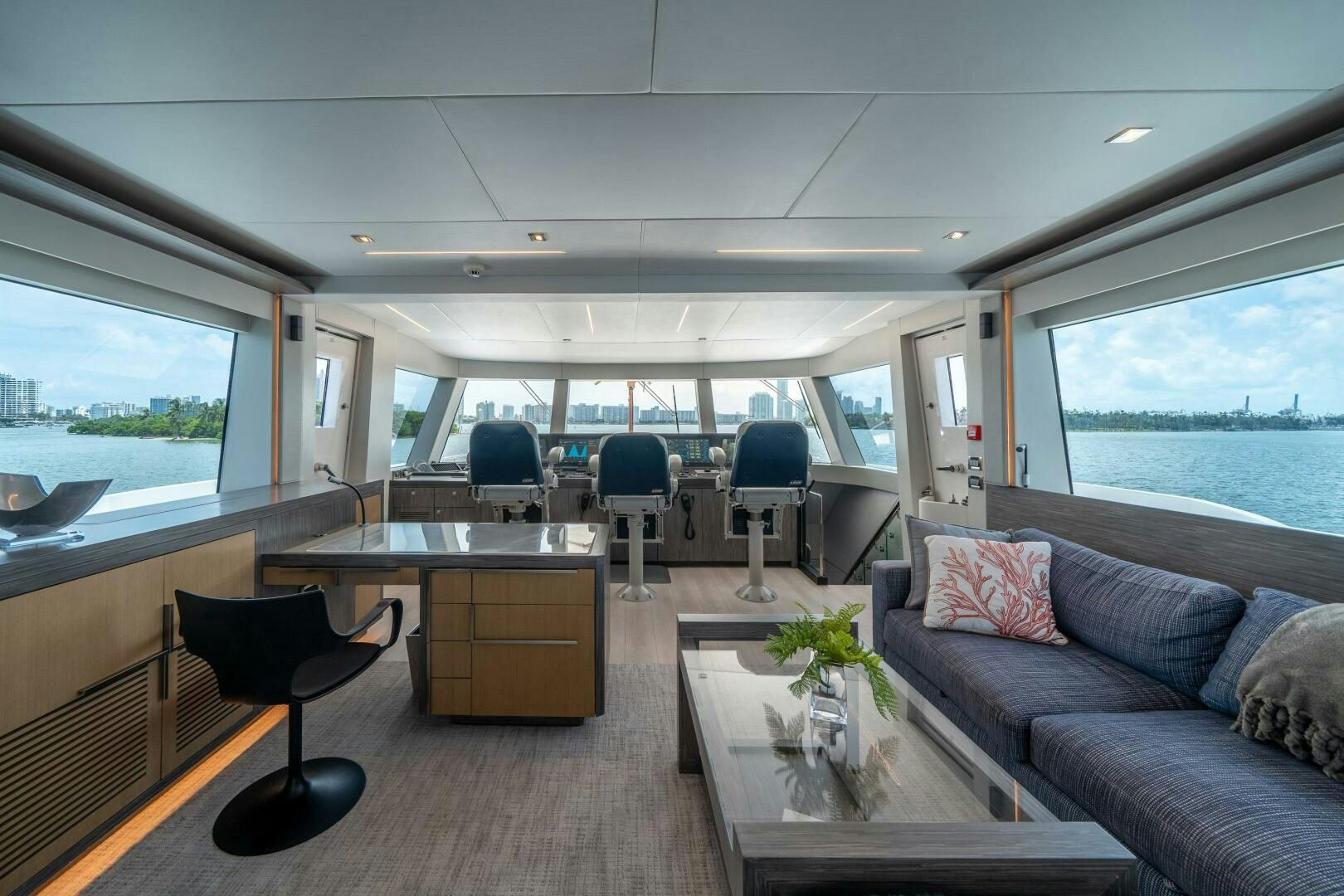 a living room with a couch and a table aboard DAY ONE Yacht for Sale