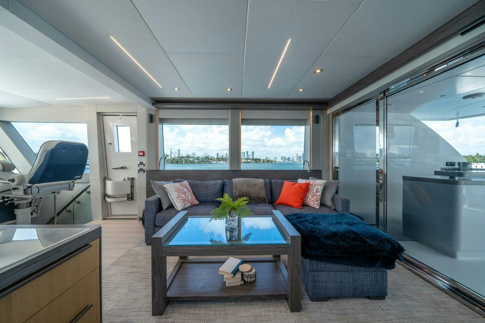 a living room with a couch and a table aboard DAY ONE Yacht for Sale