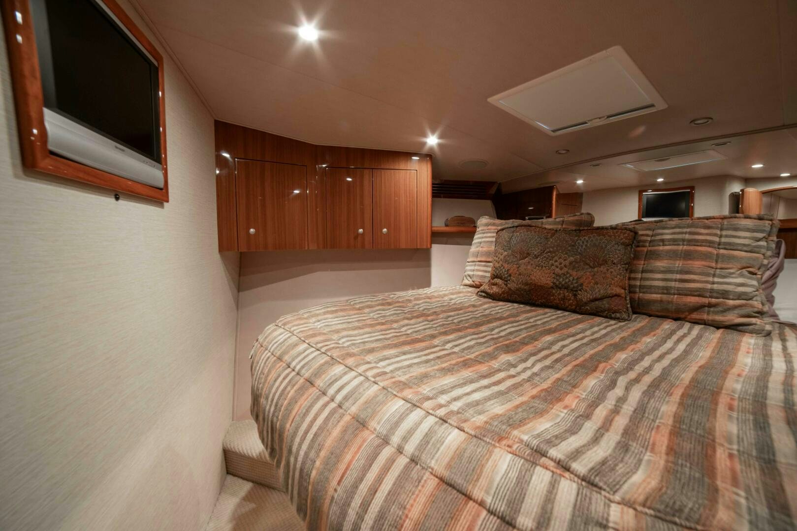 a bed with a plaid blanket aboard Z MOTIVATION Yacht for Sale