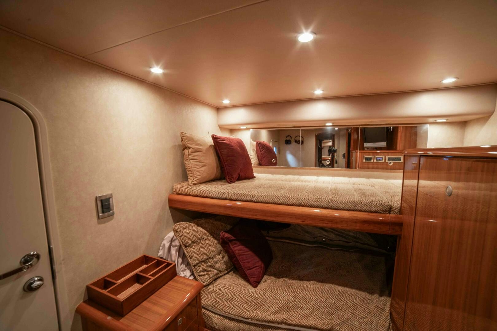 a bedroom with a bed and a dresser aboard Z MOTIVATION Yacht for Sale