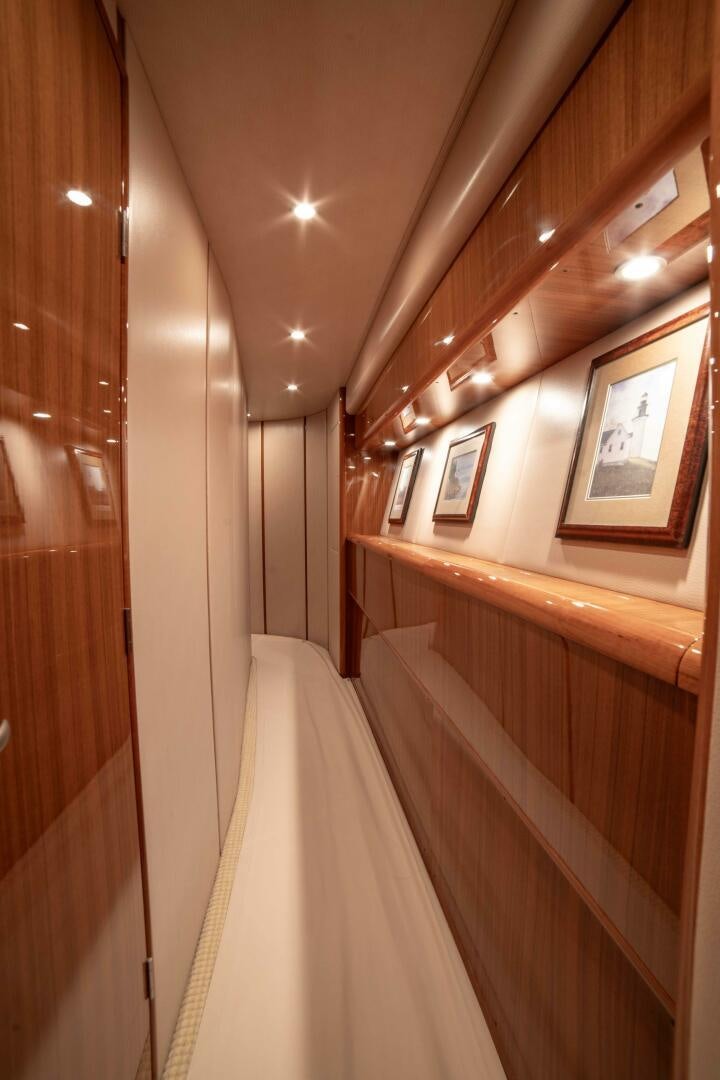 a hallway with a white staircase and paintings on the wall aboard Z MOTIVATION Yacht for Sale