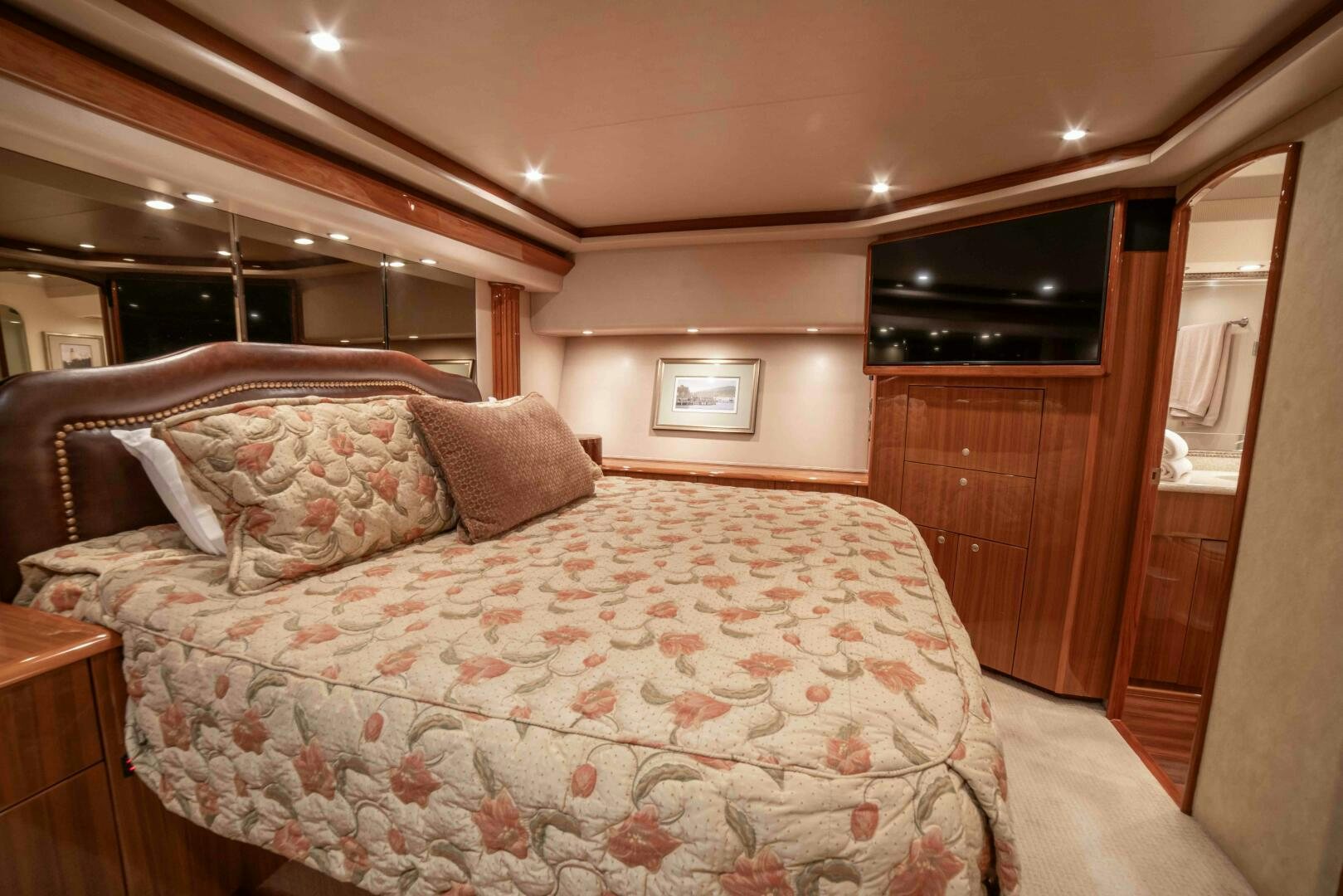 a bed with a floral blanket aboard Z MOTIVATION Yacht for Sale