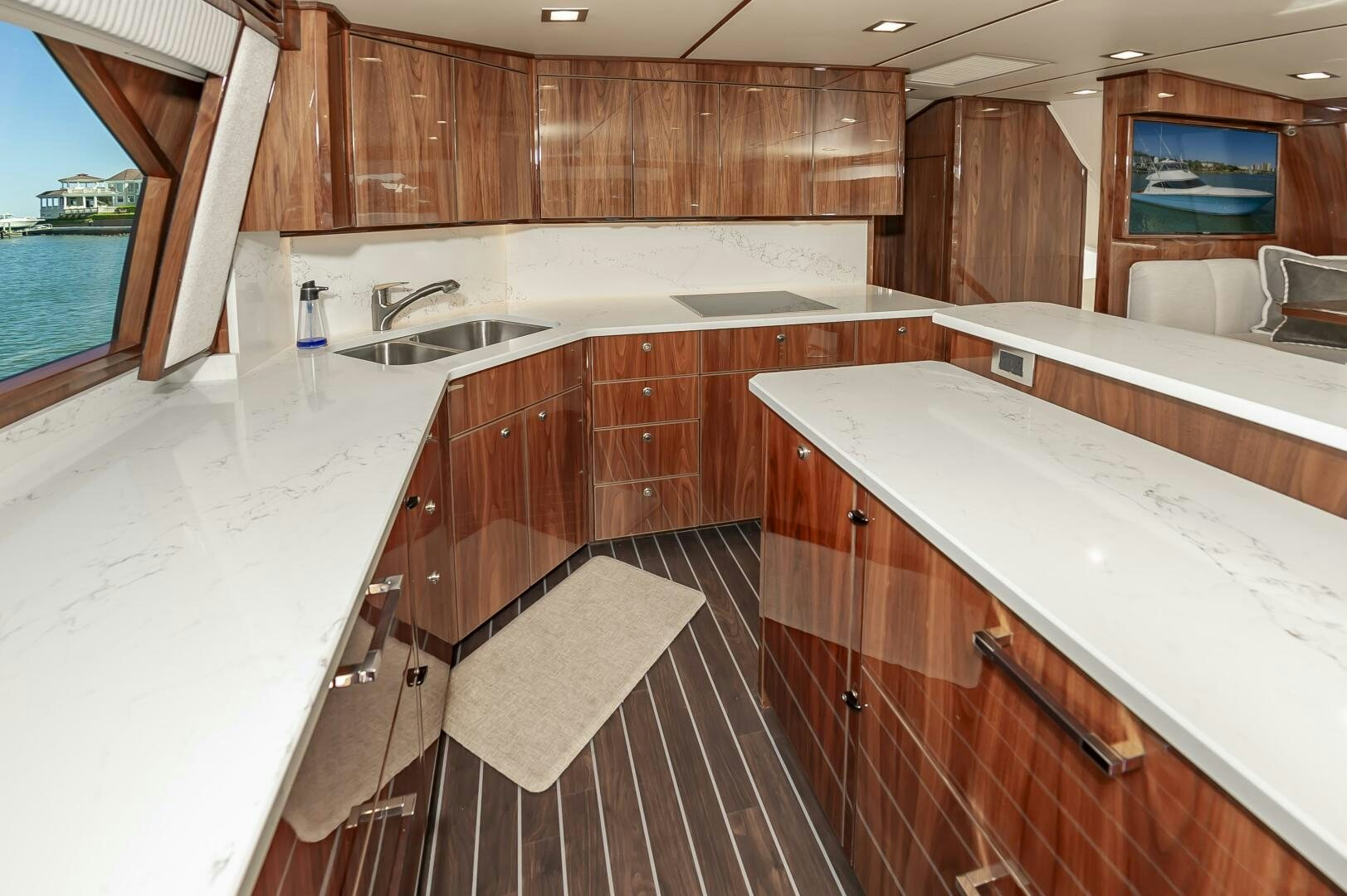 a large kitchen with wooden cabinets aboard MERCENARIA Yacht for Sale
