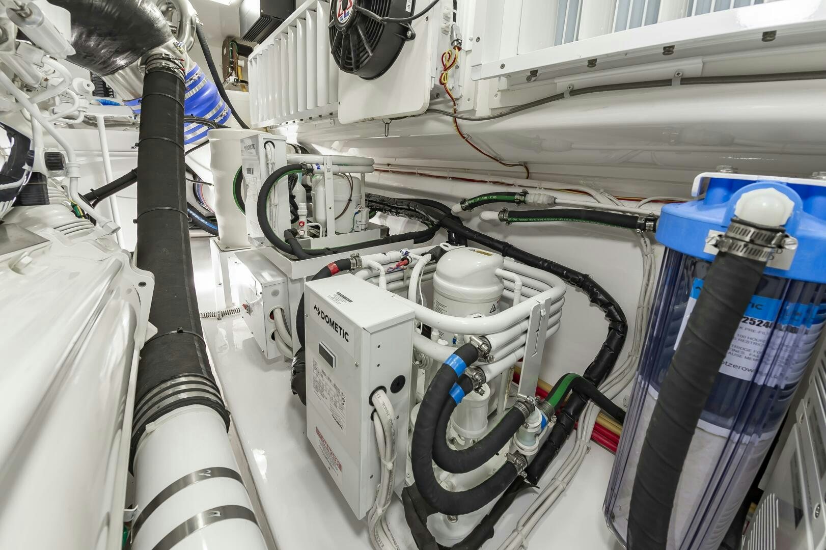 several pipes and wires in a room aboard MERCENARIA Yacht for Sale