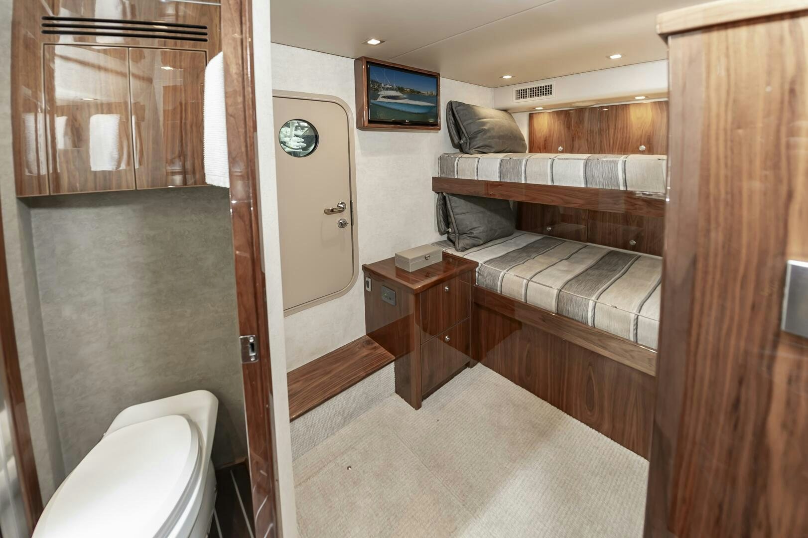 a room with a bed and a television aboard MERCENARIA Yacht for Sale