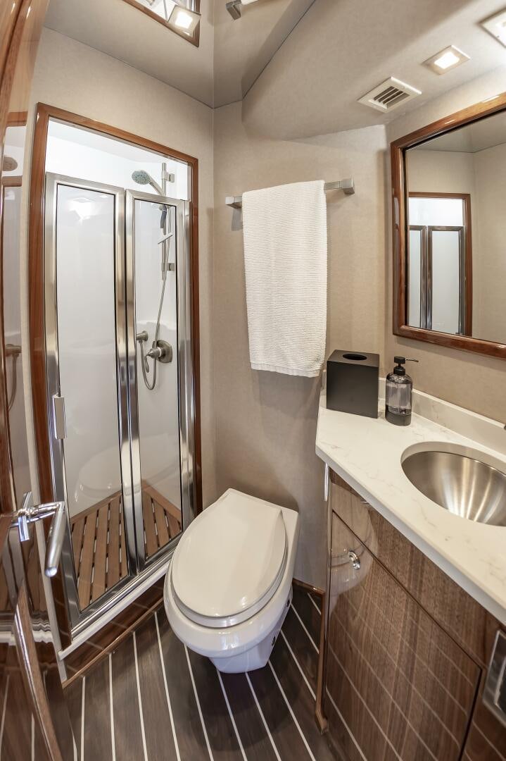 a bathroom with a glass shower door aboard MERCENARIA Yacht for Sale