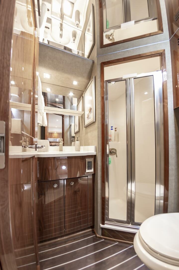 a bathroom with a glass shower aboard MERCENARIA Yacht for Sale