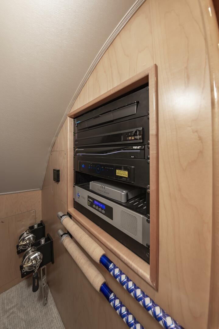 a wood shelf with a few electrical devices on it aboard MERCENARIA Yacht for Sale