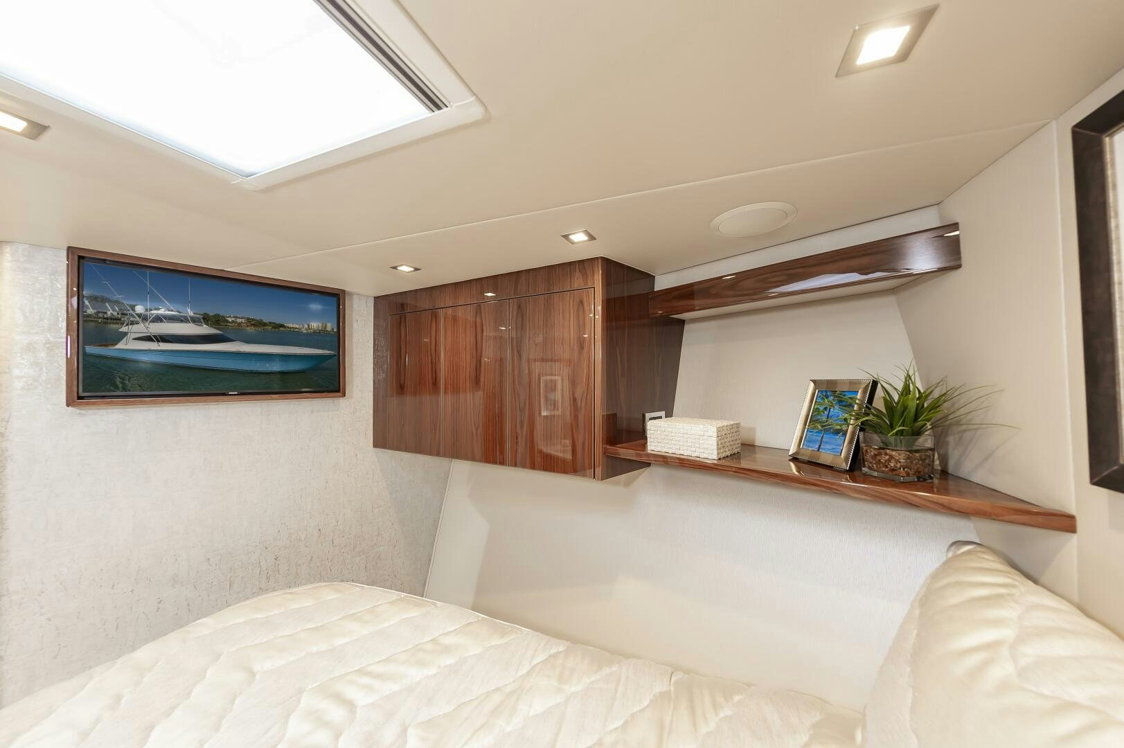 a bedroom with a bed and a desk aboard MERCENARIA Yacht for Sale