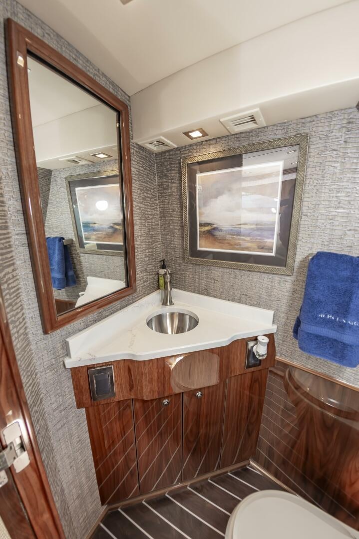 a bathroom with a sink and mirror aboard MERCENARIA Yacht for Sale