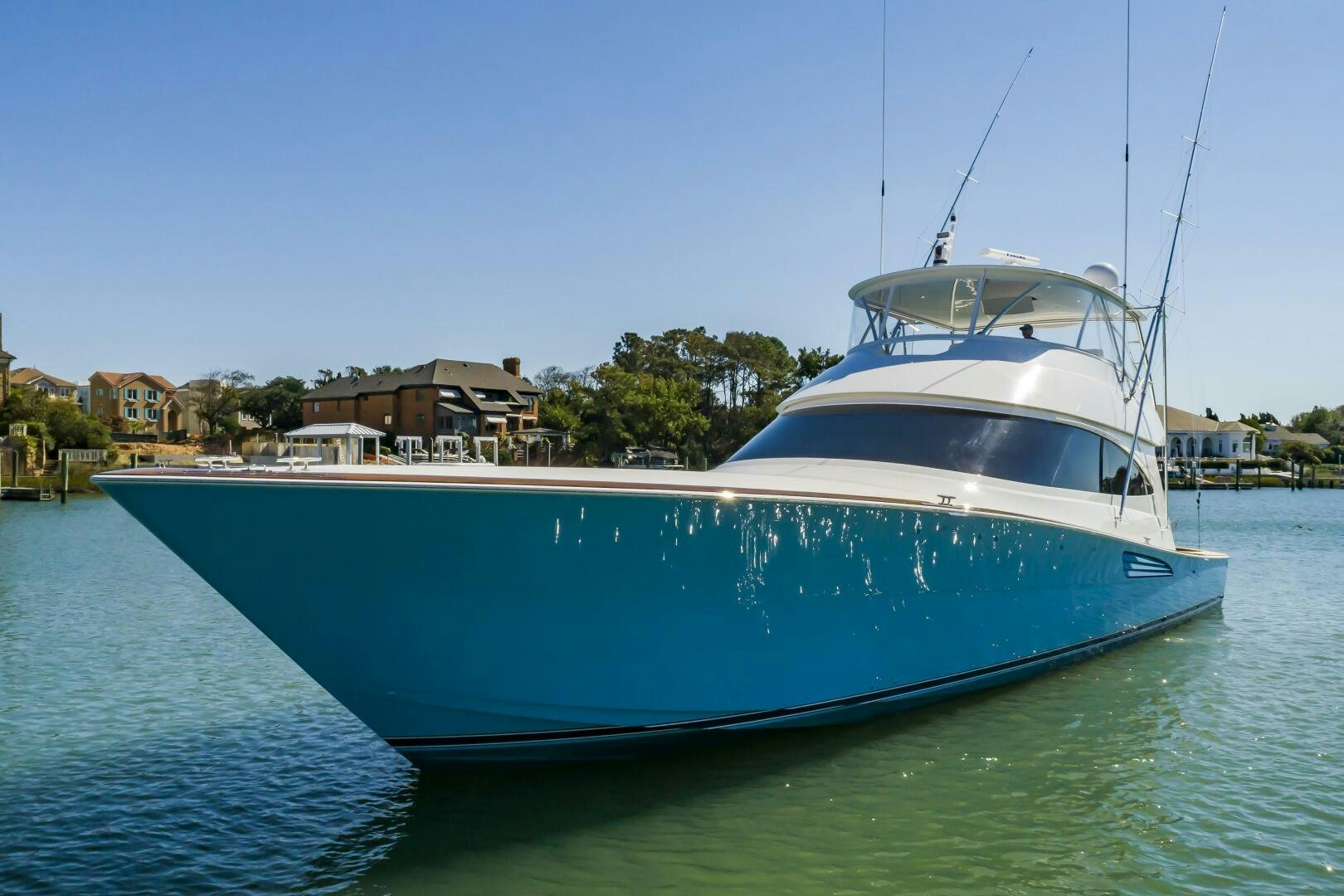 a large white boat in a harbor aboard MERCENARIA Yacht for Sale