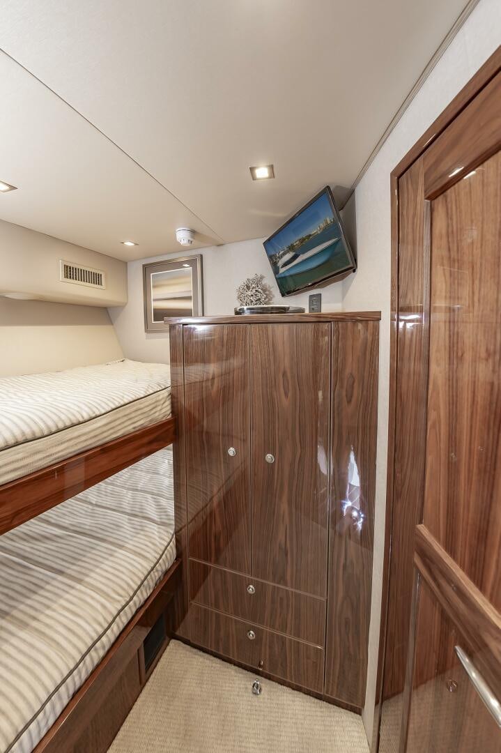 a room with a bed and a television aboard MERCENARIA Yacht for Sale