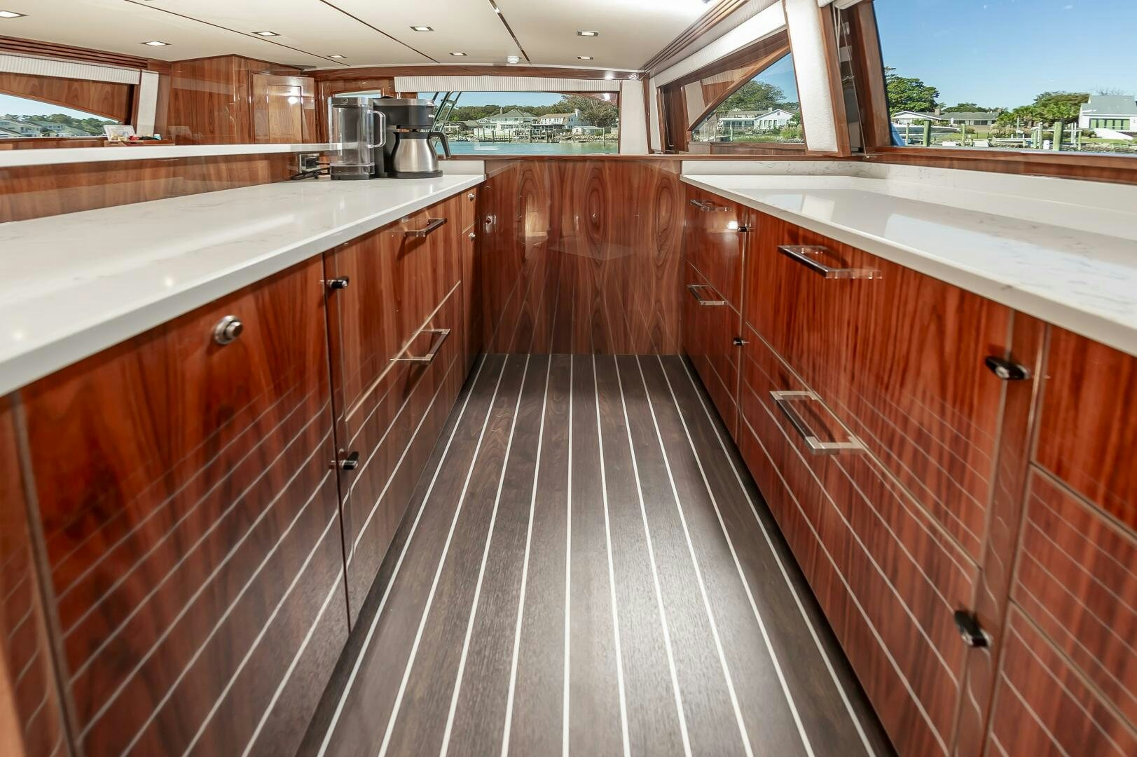 a kitchen with wooden cabinets aboard MERCENARIA Yacht for Sale