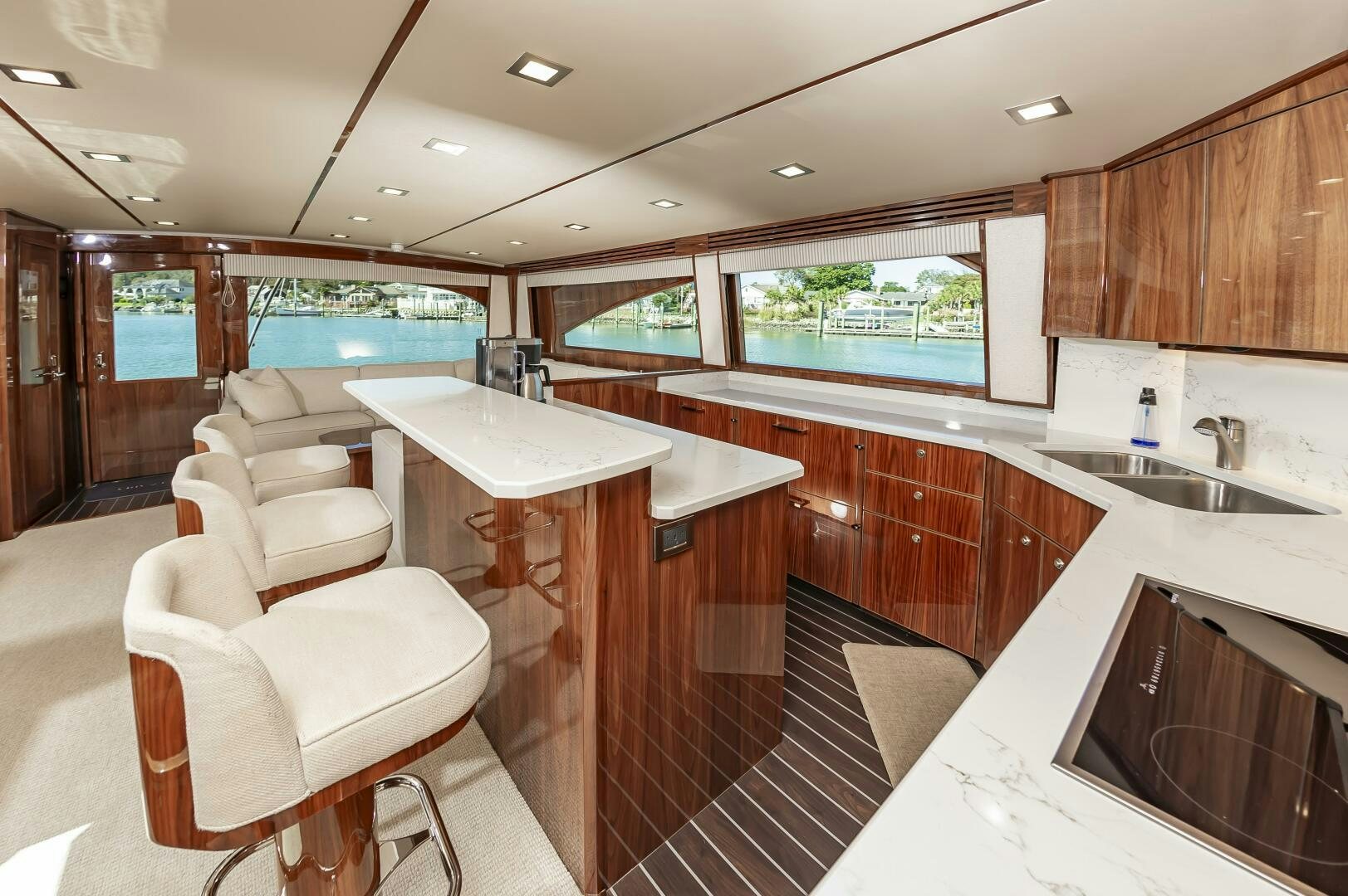 a kitchen with a bar and a table aboard MERCENARIA Yacht for Sale