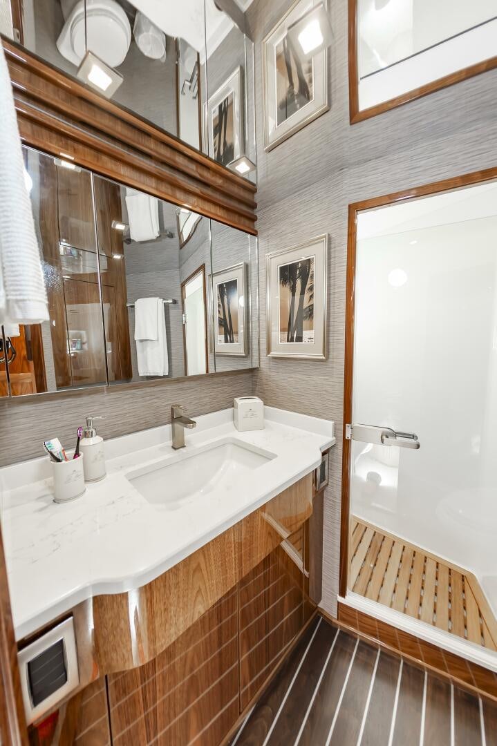 a bathroom with a large mirror aboard MERCENARIA Yacht for Sale