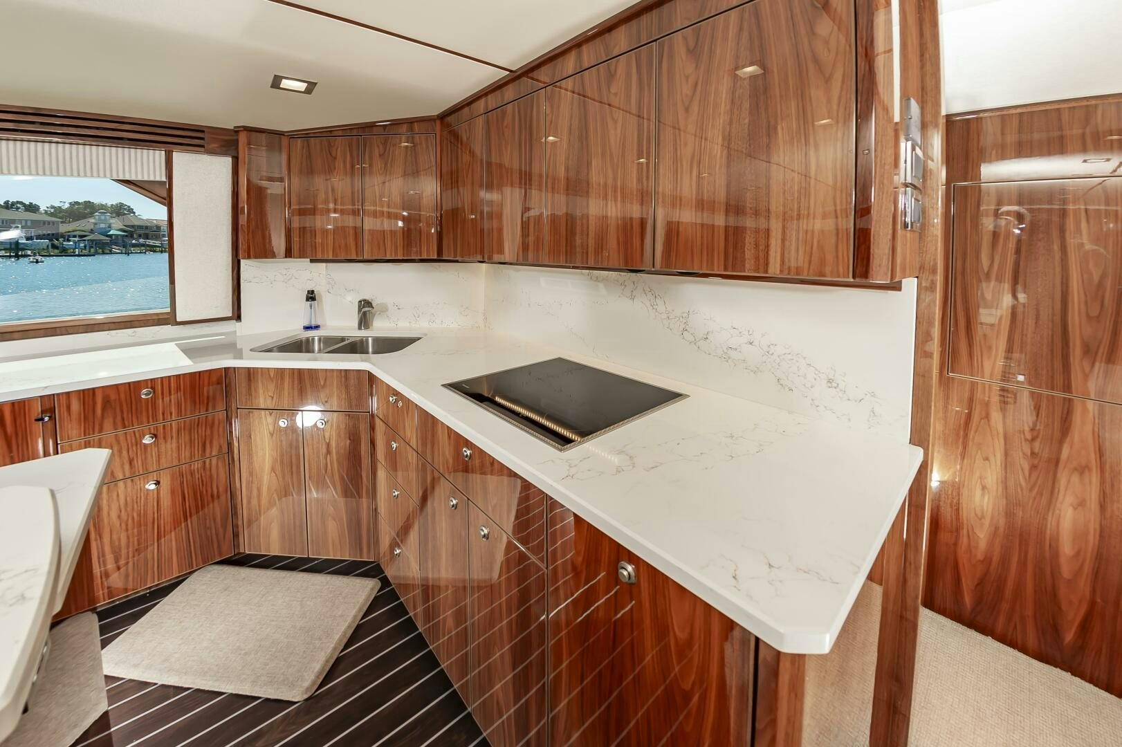 a kitchen with wooden cabinets aboard MERCENARIA Yacht for Sale