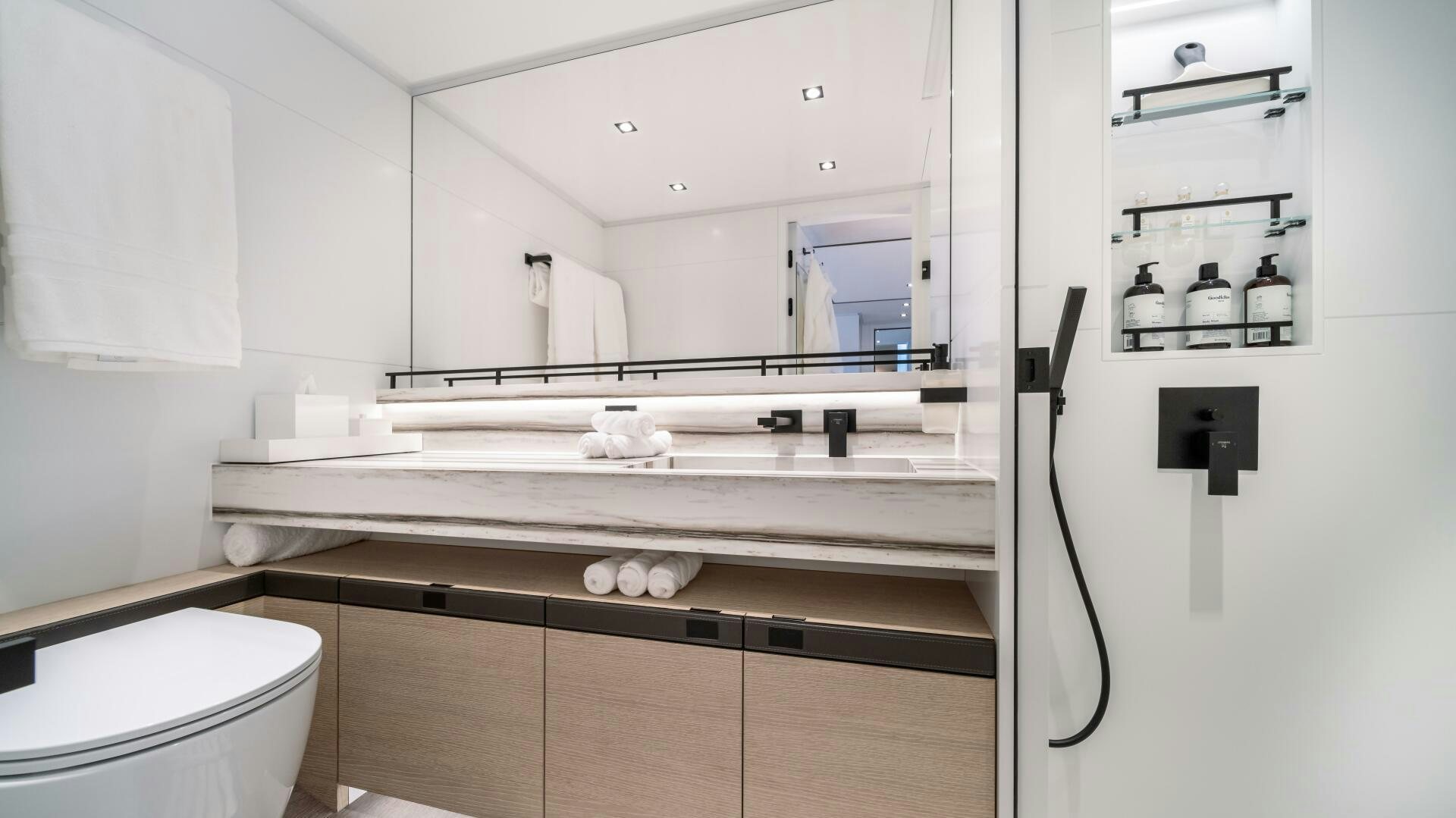 a bathroom with a large mirror aboard FELLOWSHIP II Yacht for Sale