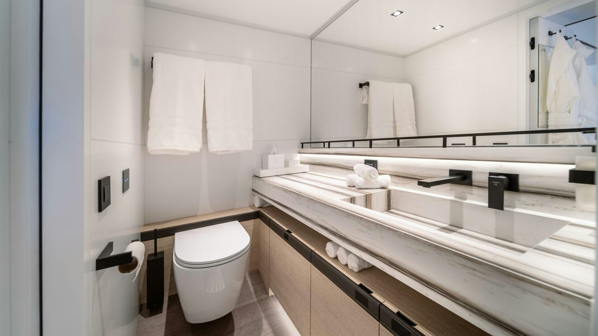 a bathroom with a large mirror aboard FELLOWSHIP II Yacht for Sale