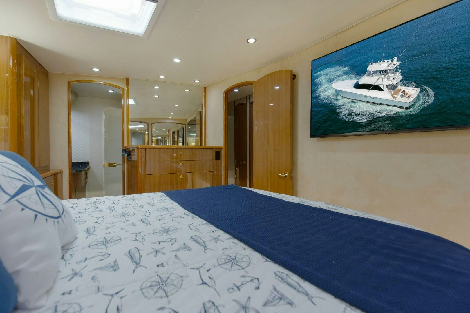 a bedroom with a bed and a television on the wall aboard JESSI SUE Yacht for Sale