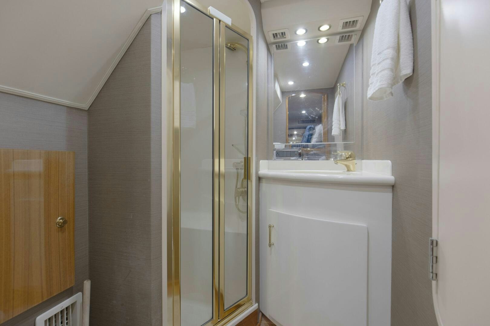 a bathroom with a glass shower aboard JESSI SUE Yacht for Sale