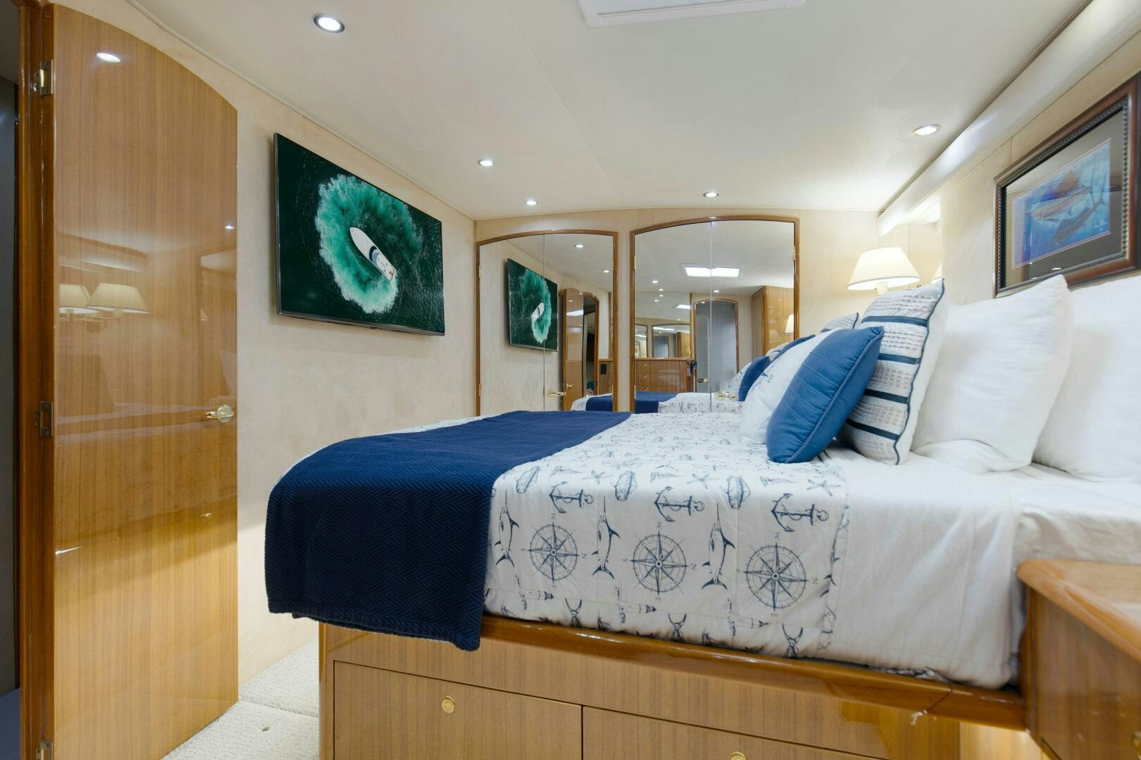 a bed with blue sheets aboard JESSI SUE Yacht for Sale