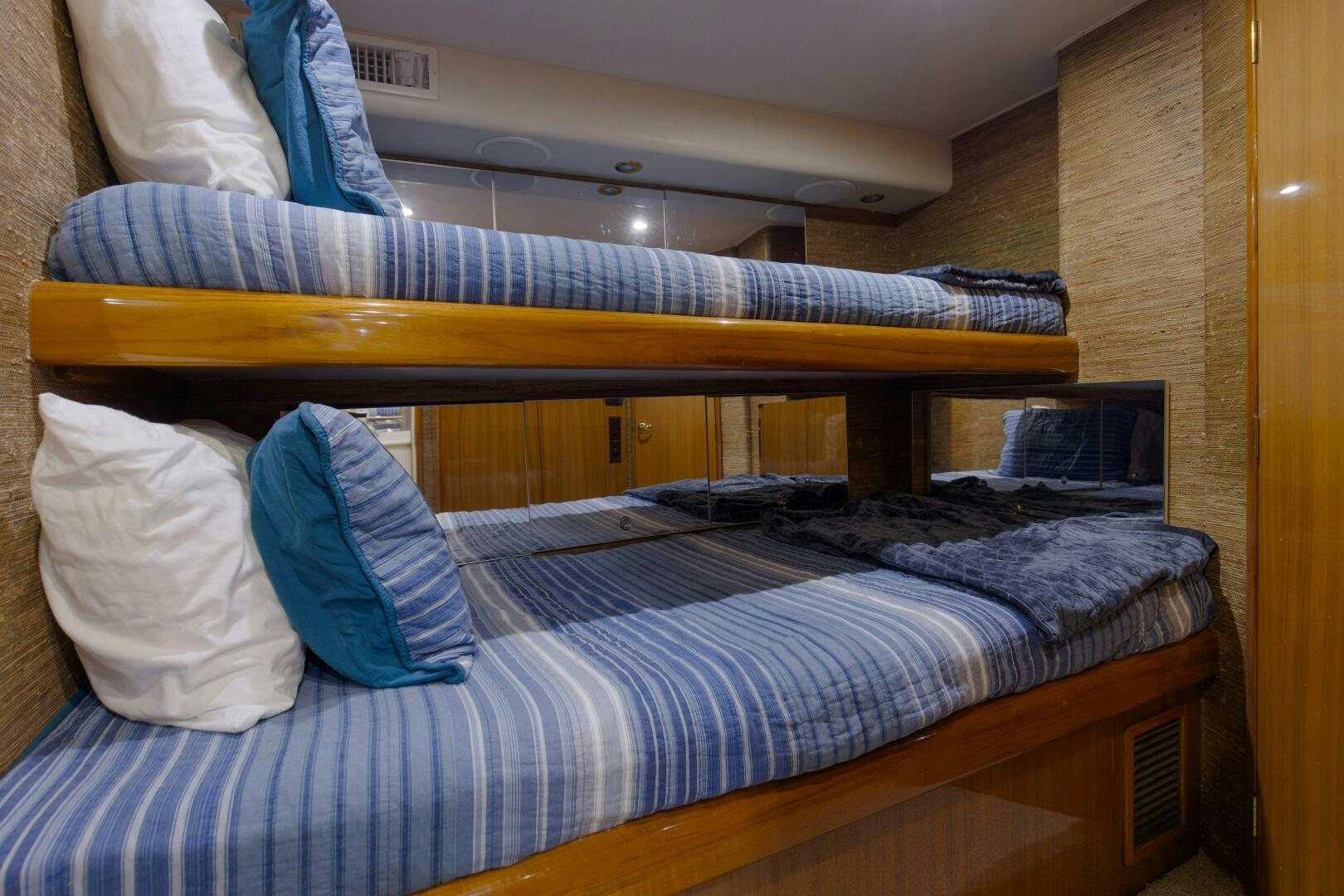 a bed with blue and white sheets aboard JESSI SUE Yacht for Sale