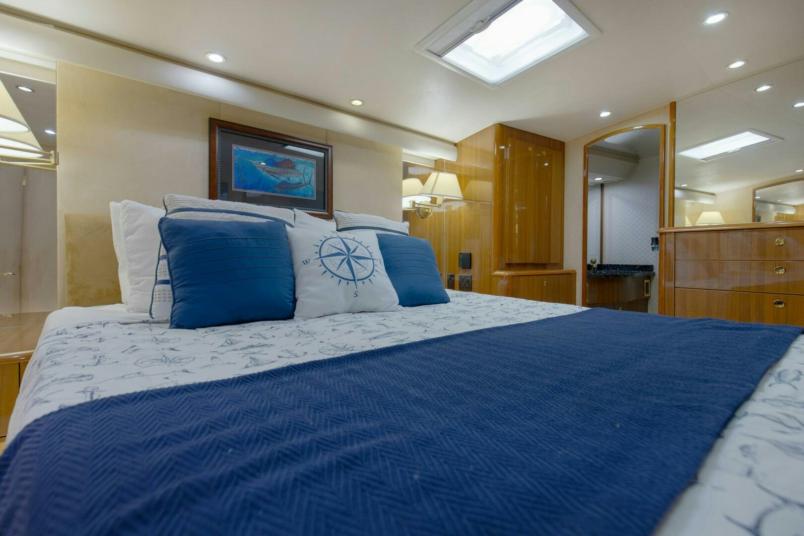 a large bed with blue and white sheets aboard JESSI SUE Yacht for Sale