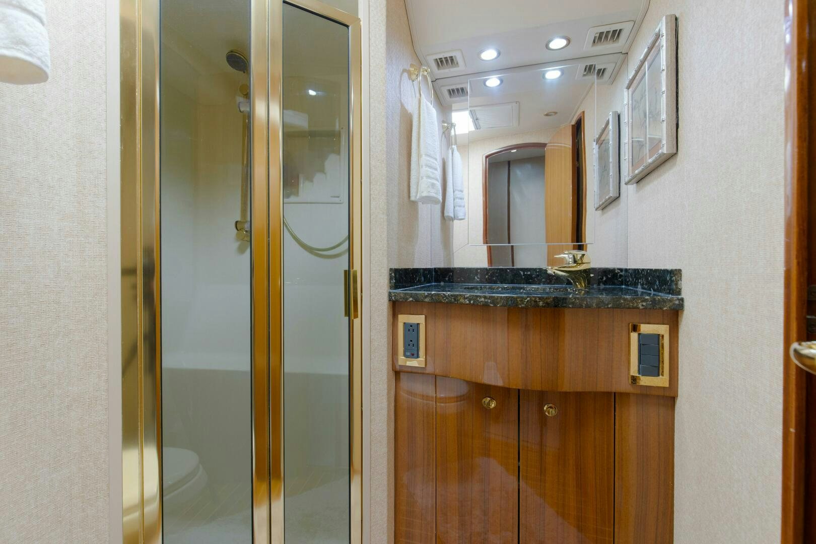 a bathroom with a countertop sink and a mirror aboard JESSI SUE Yacht for Sale
