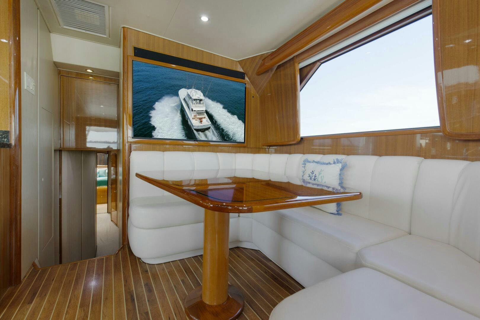 a living room with a table and couches aboard JESSI SUE Yacht for Sale