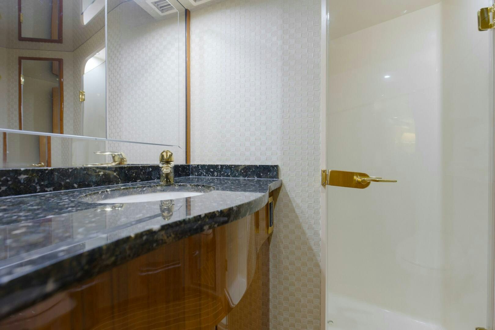 a bathroom with a sink and a mirror aboard JESSI SUE Yacht for Sale