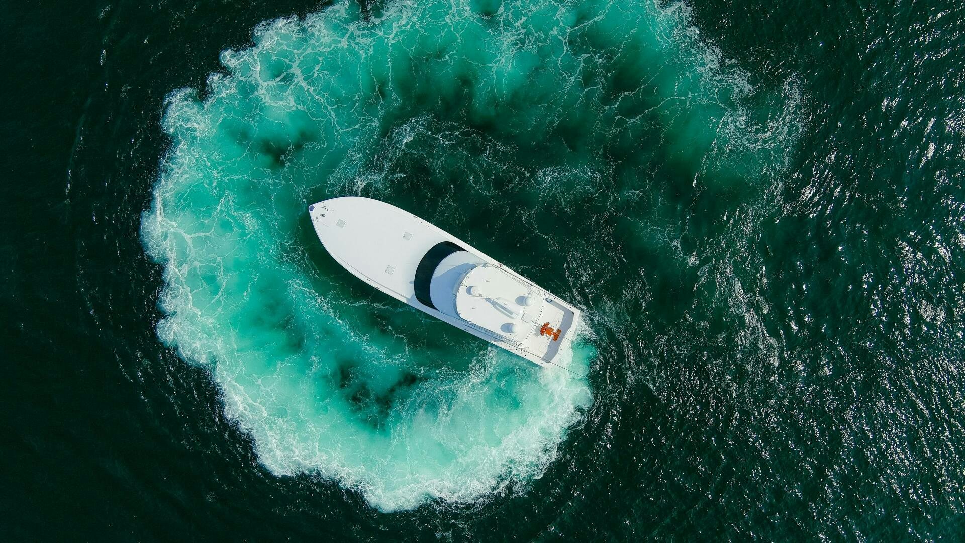 a white surfboard in the water aboard JESSI SUE Yacht for Sale