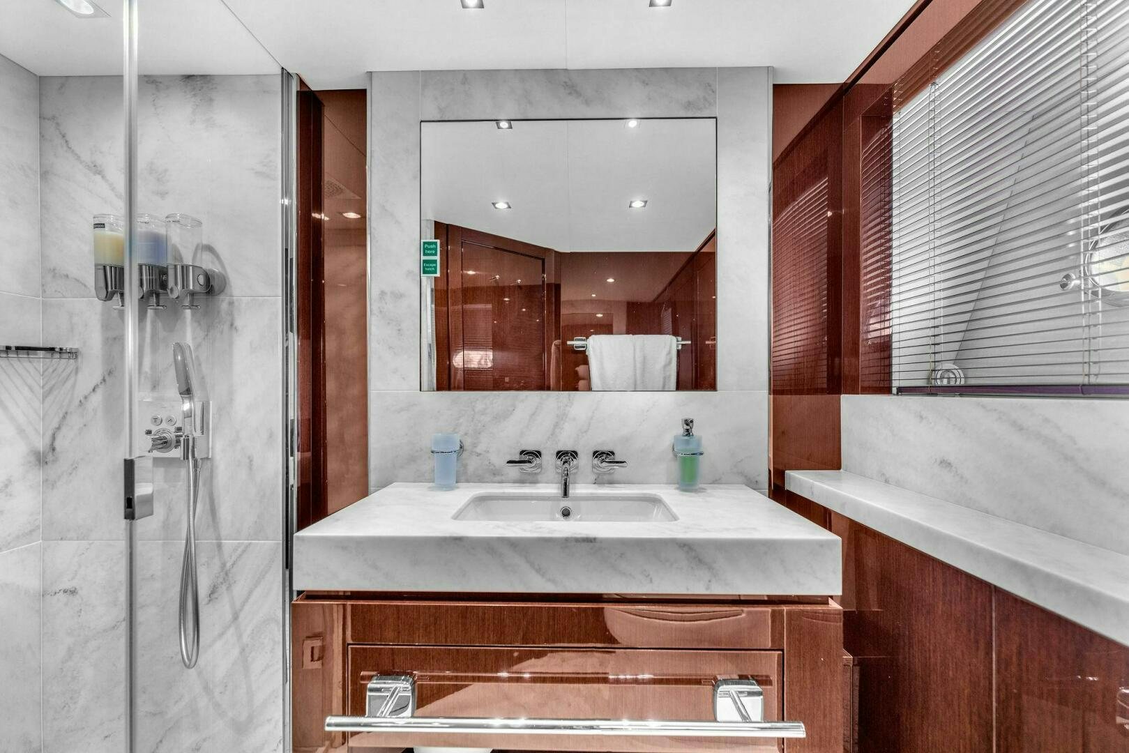 a bathroom with a large mirror aboard KARILLIAN & COMPANY Yacht for Sale