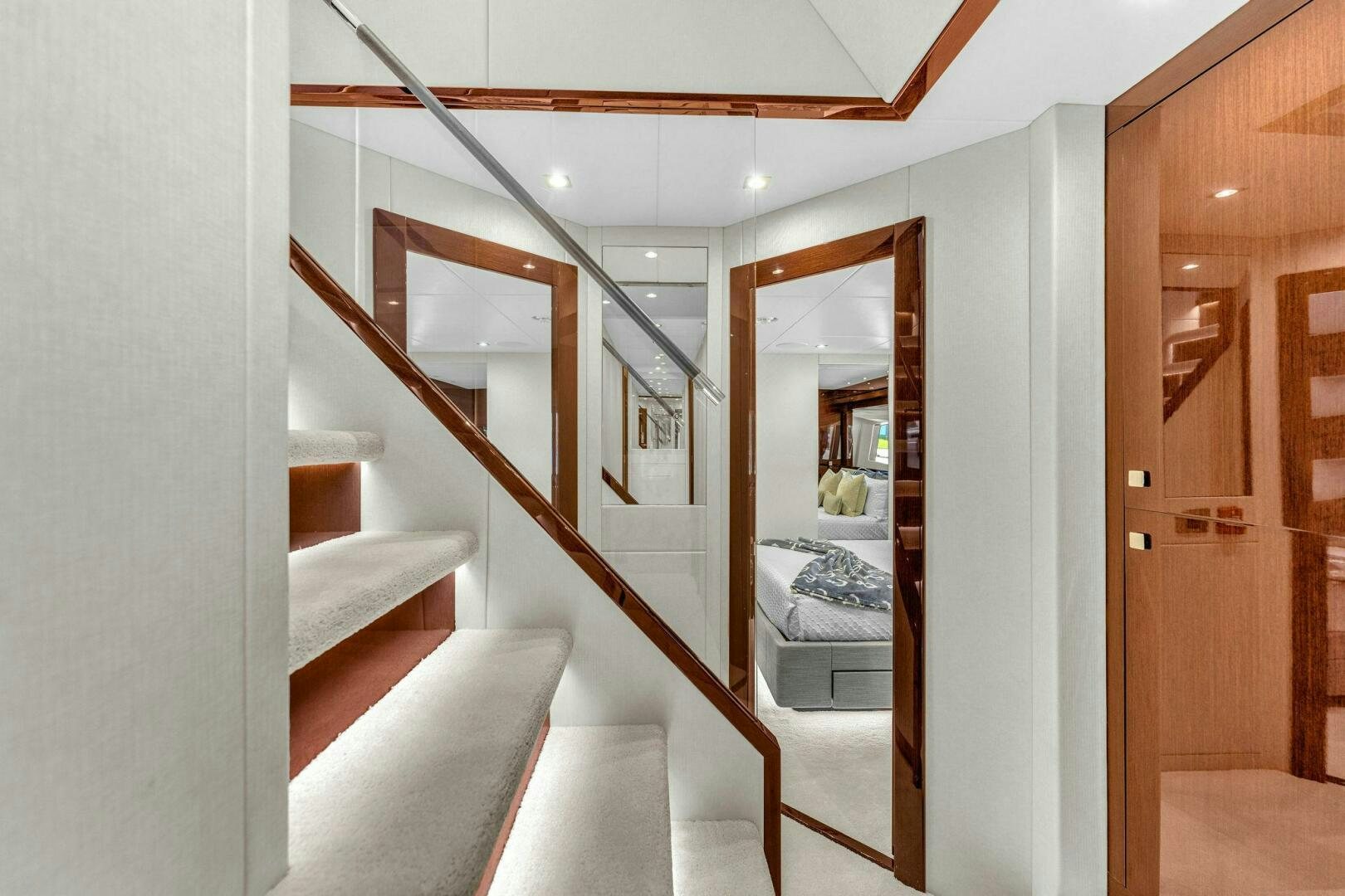 a room with a bed and a mirror aboard KARILLIAN & COMPANY Yacht for Sale