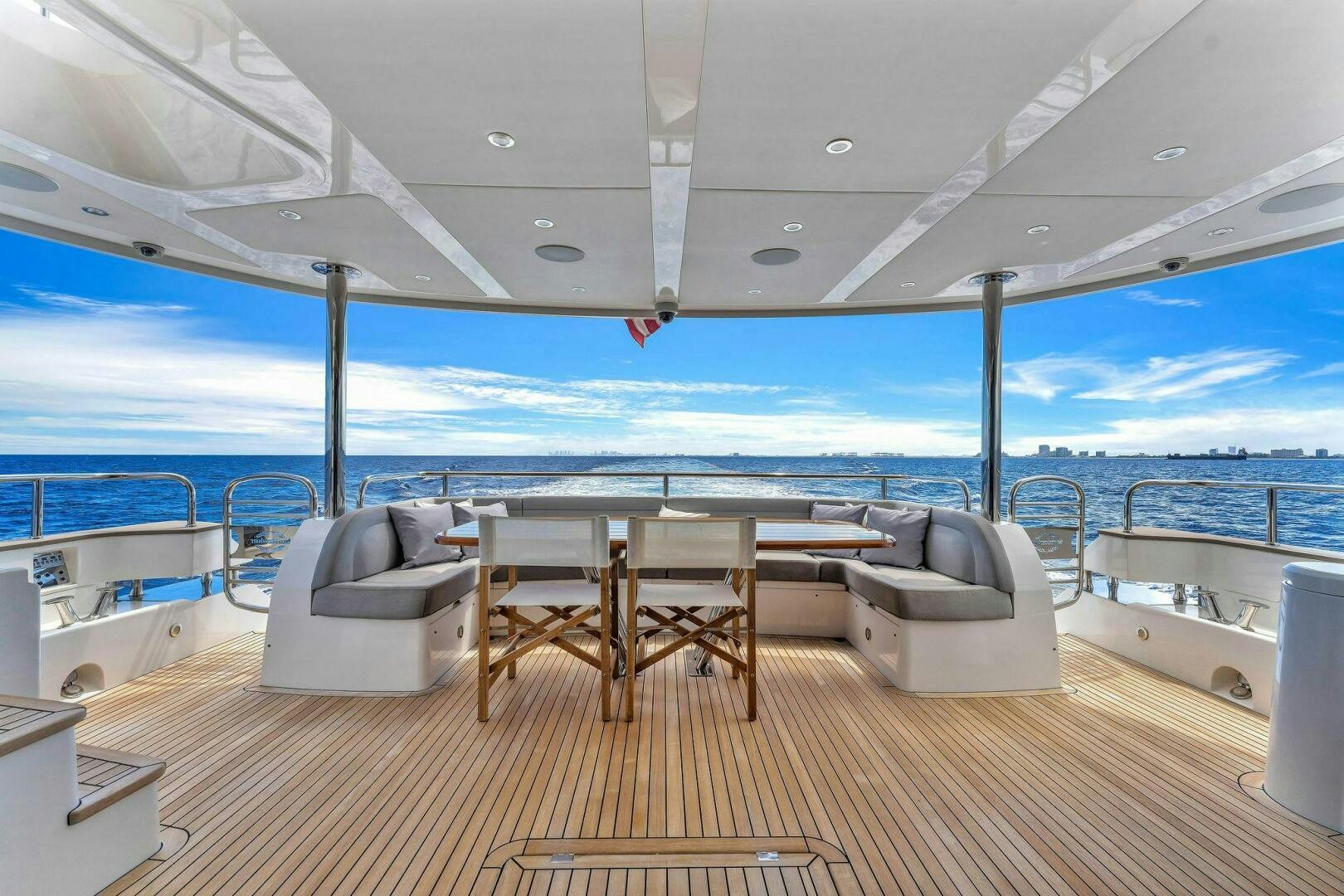 a deck with a table and chairs on it aboard KARILLIAN & COMPANY Yacht for Sale