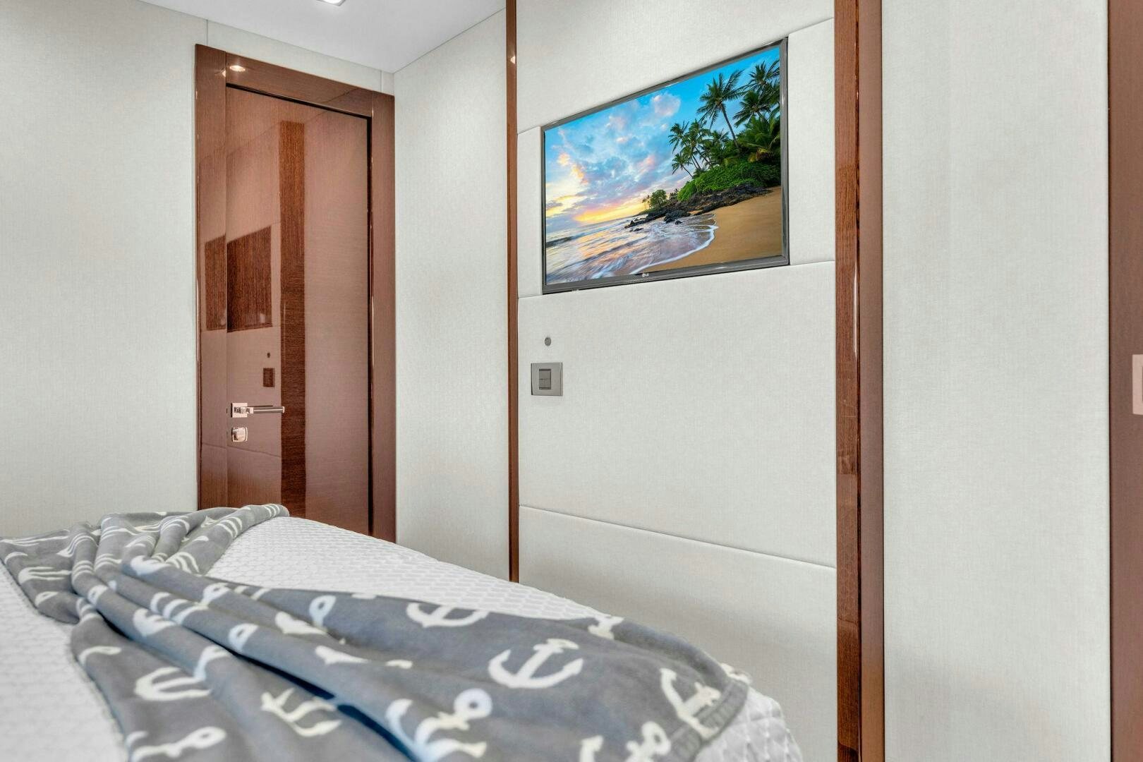 a bed with a painting on the wall aboard KARILLIAN & COMPANY Yacht for Sale