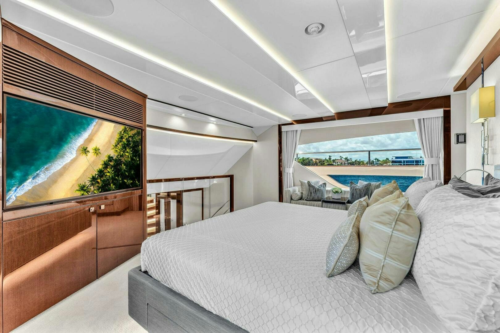 a room with a bed and a balcony aboard KARILLIAN & COMPANY Yacht for Sale