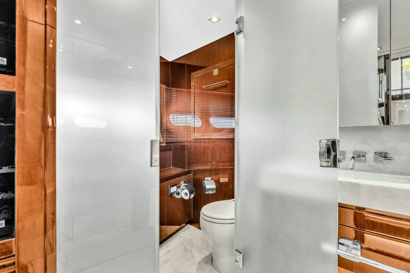 a bathroom with a toilet and a sink aboard KARILLIAN & COMPANY Yacht for Sale