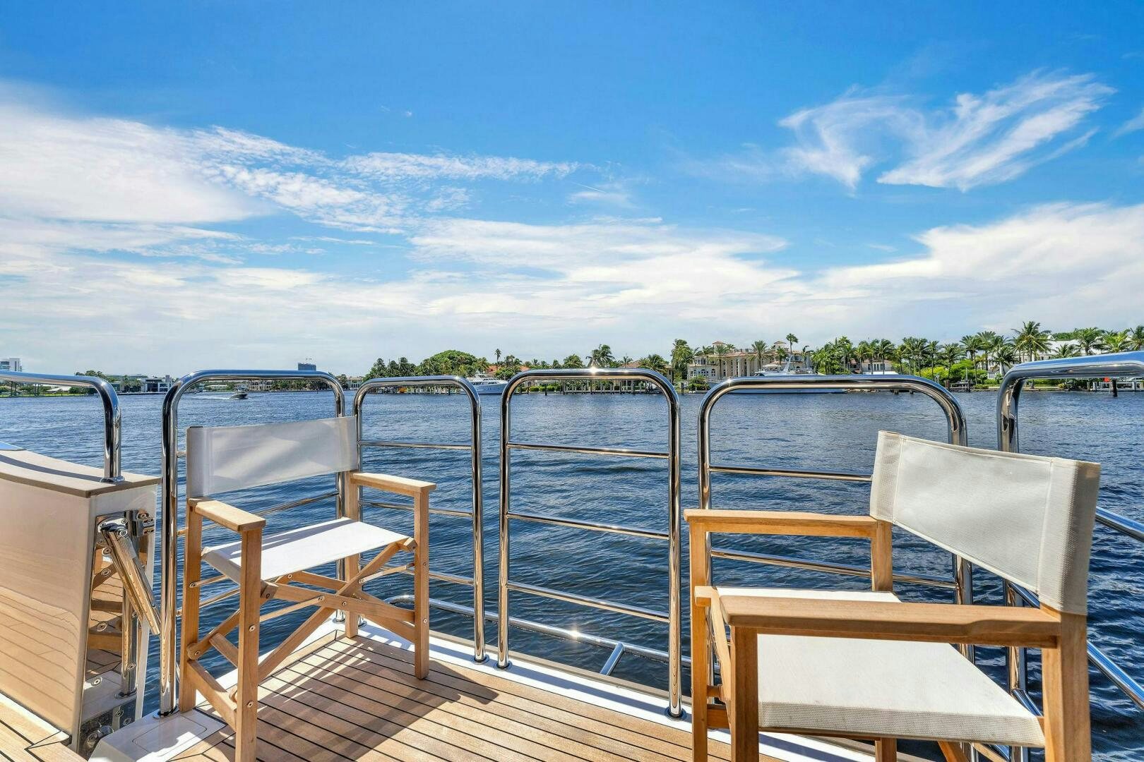 a deck with chairs and a body of water aboard KARILLIAN & COMPANY Yacht for Sale