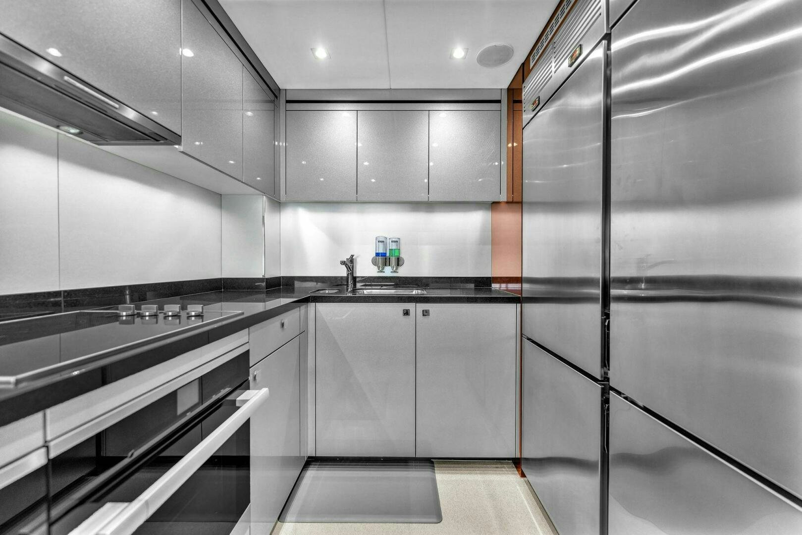 a kitchen with stainless steel appliances aboard KARILLIAN & COMPANY Yacht for Sale