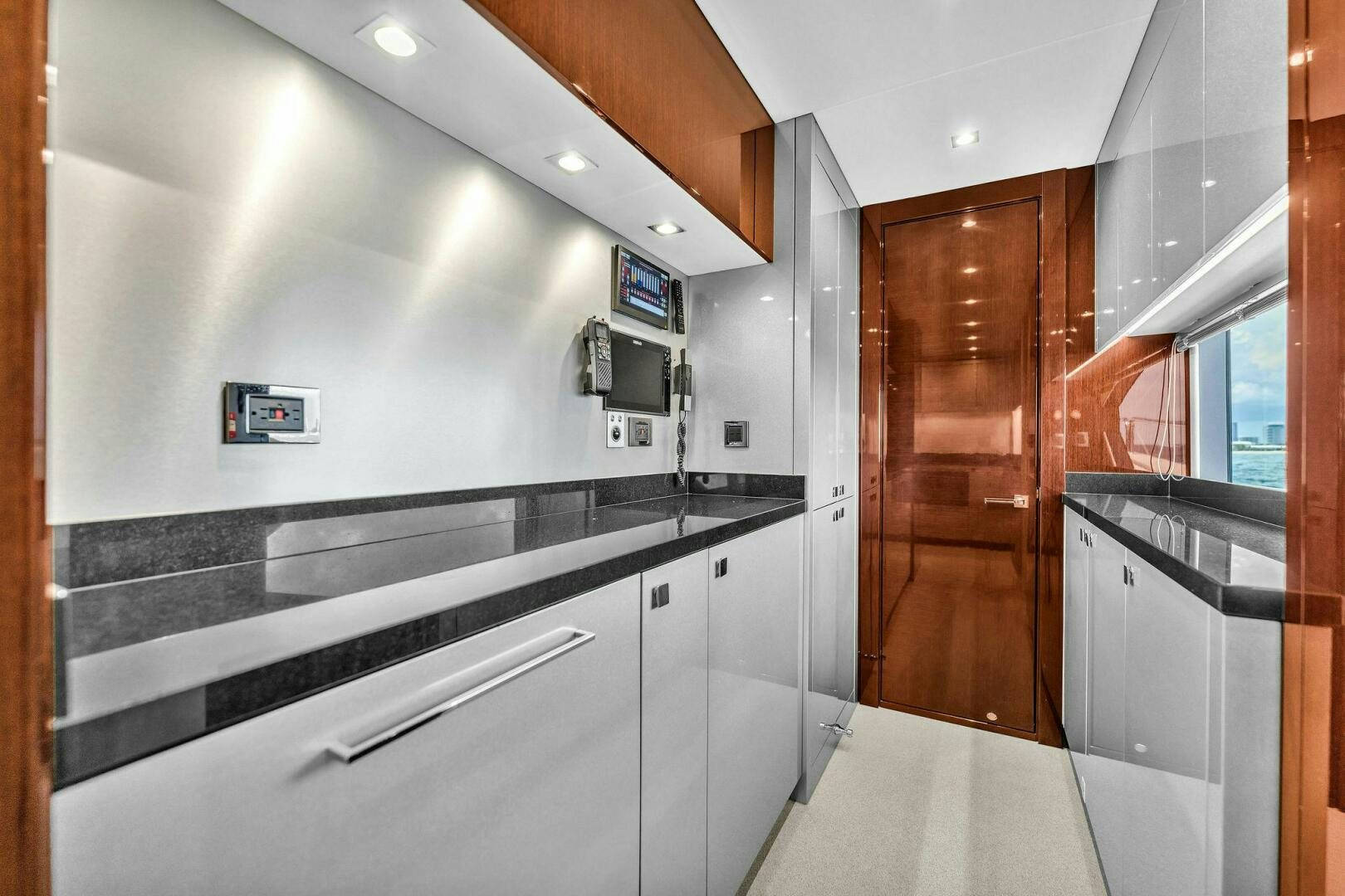 a kitchen with white cabinets aboard KARILLIAN & COMPANY Yacht for Sale