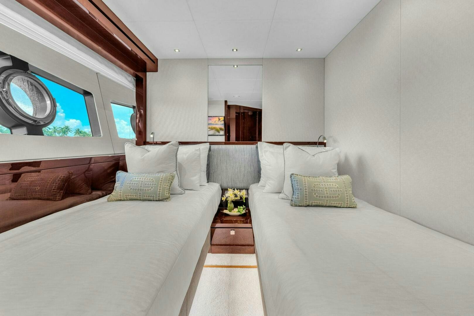a room with a bed and a mirror aboard KARILLIAN & COMPANY Yacht for Sale
