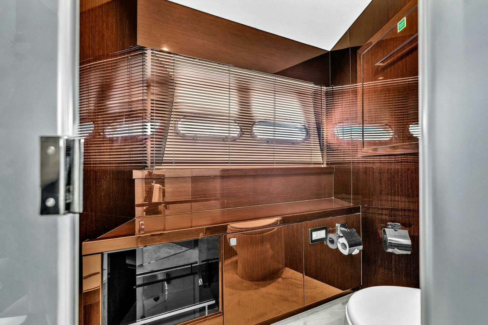 a bathroom with wooden cabinets aboard KARILLIAN & COMPANY Yacht for Sale