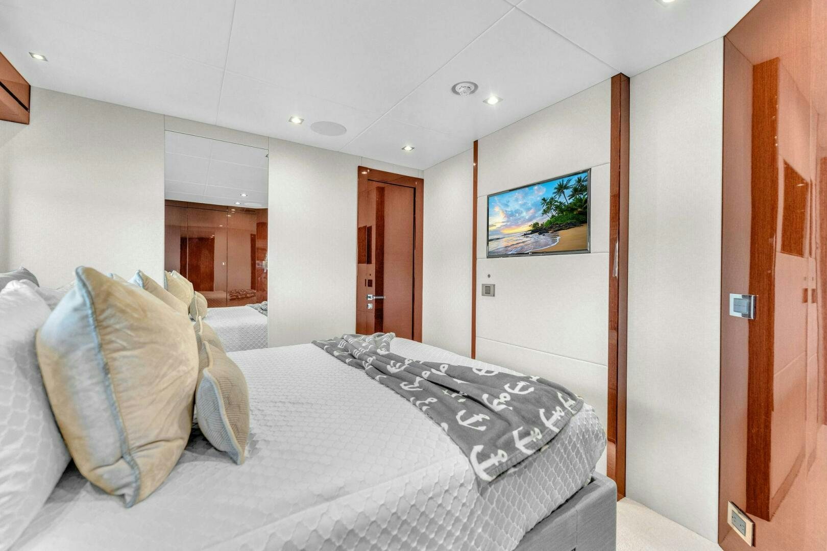 a bedroom with a bed and a television aboard KARILLIAN & COMPANY Yacht for Sale
