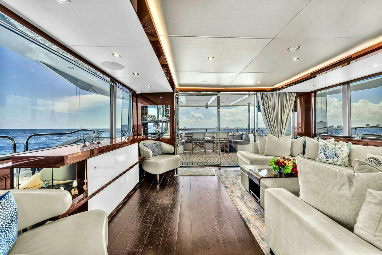 a large living room with a large window aboard KARILLIAN & COMPANY Yacht for Sale