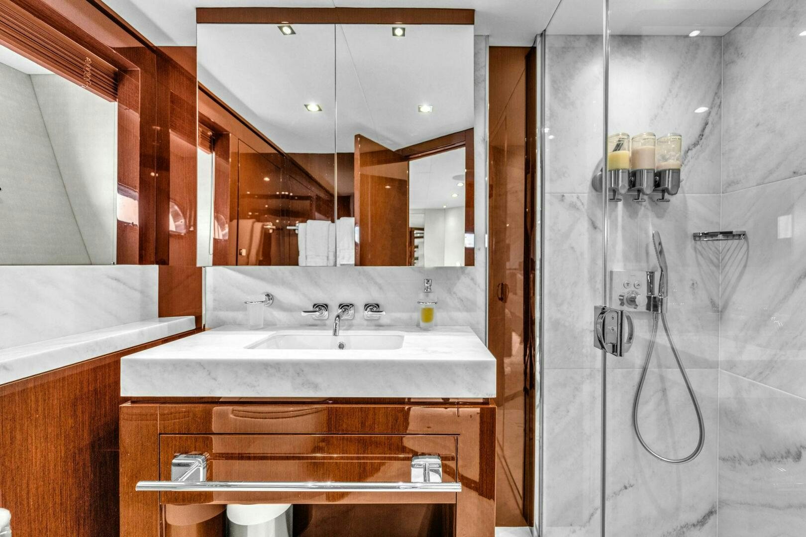 a bathroom with a sink and a mirror aboard KARILLIAN & COMPANY Yacht for Sale