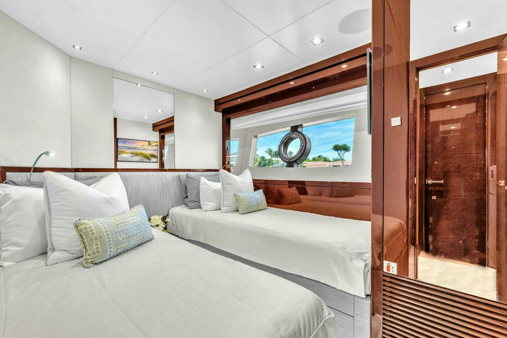a room with a bed and a mirror aboard KARILLIAN & COMPANY Yacht for Sale