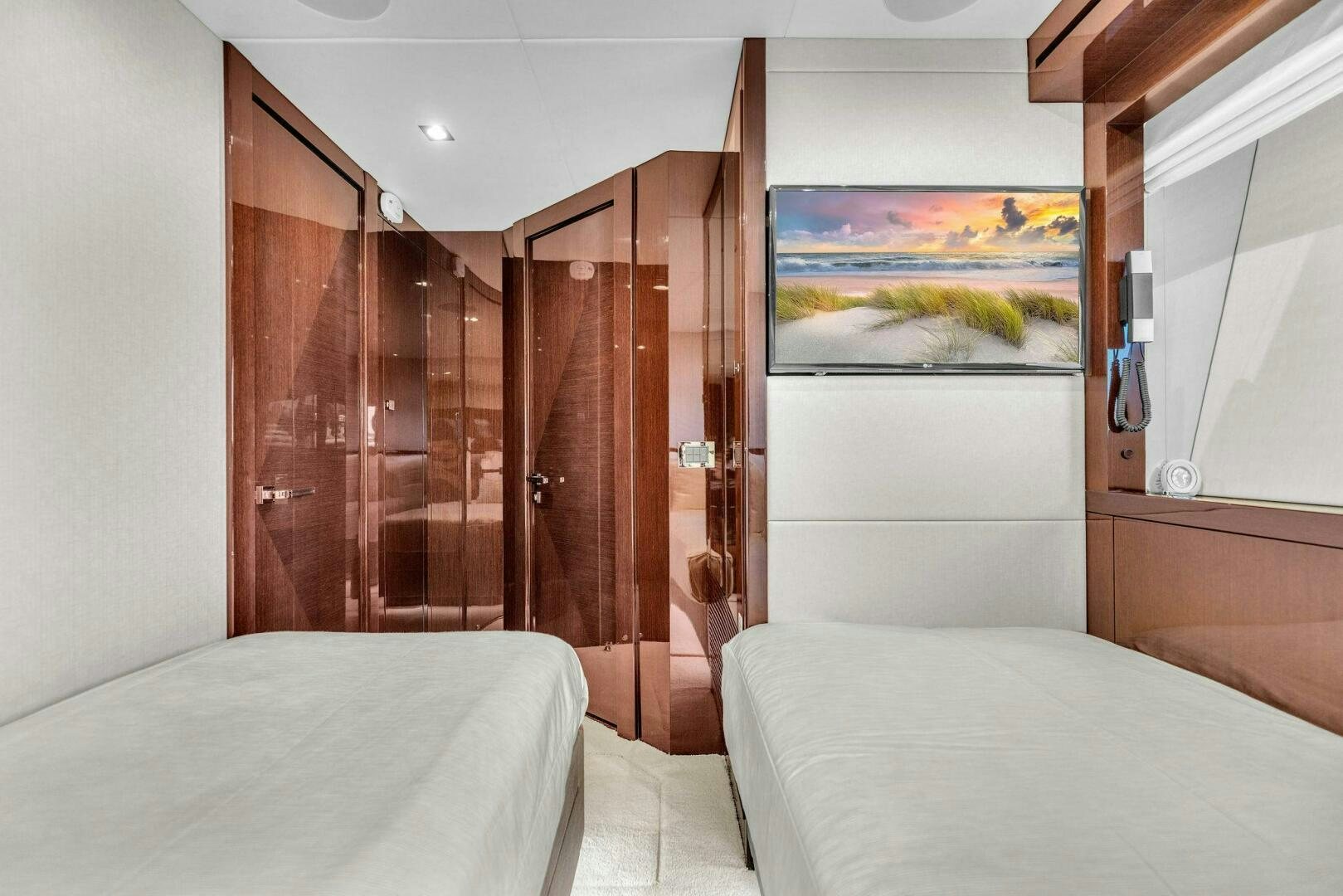 a bedroom with a bed and a wood door aboard KARILLIAN & COMPANY Yacht for Sale