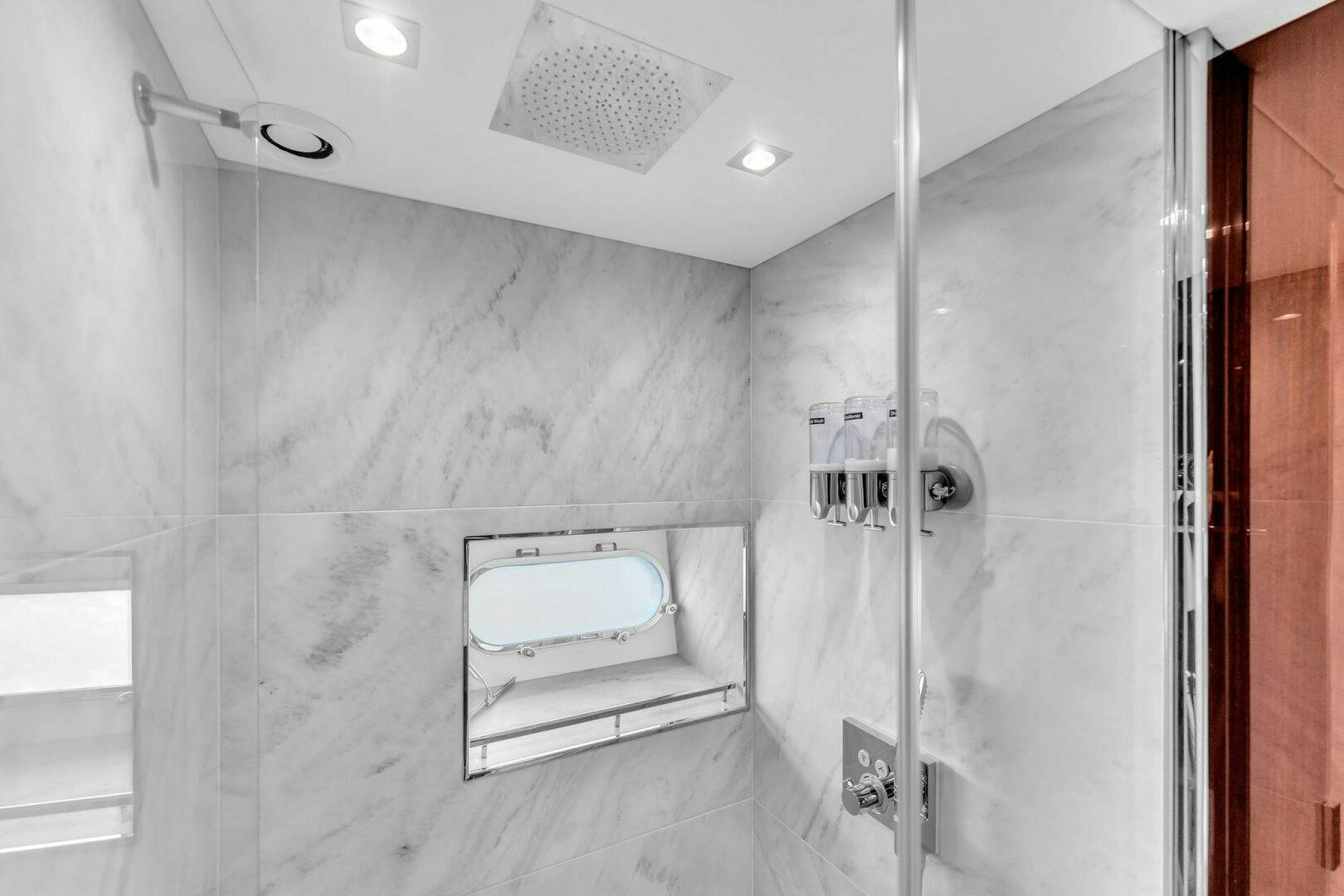 a bathroom with a glass shower aboard KARILLIAN & COMPANY Yacht for Sale