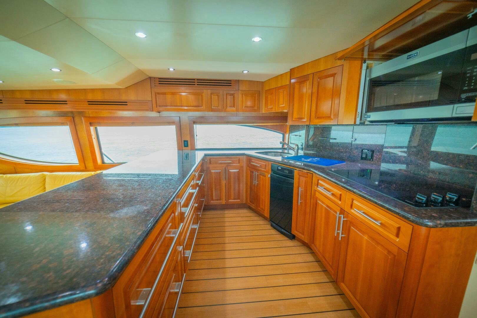 a kitchen with wooden cabinets aboard MARLIN CLIPPER Yacht for Sale