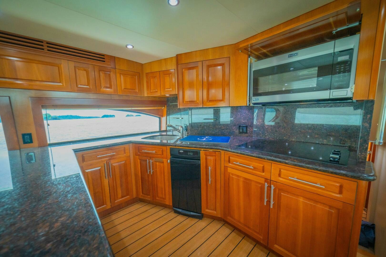 a kitchen with wooden cabinets aboard MARLIN CLIPPER Yacht for Sale